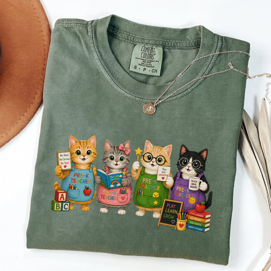 Moss T-shirt with four cartoon cats dressed as colorful pre-K teachers.