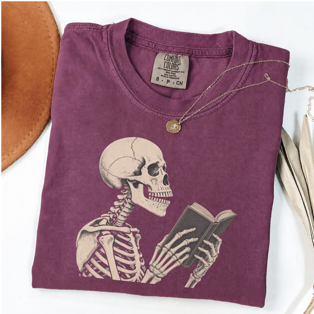 Pepper Comfort Colors book lover shirt featuring a vintage skeleton reading