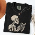 Black Comfort Colors book lover shirt featuring a vintage skeleton reading