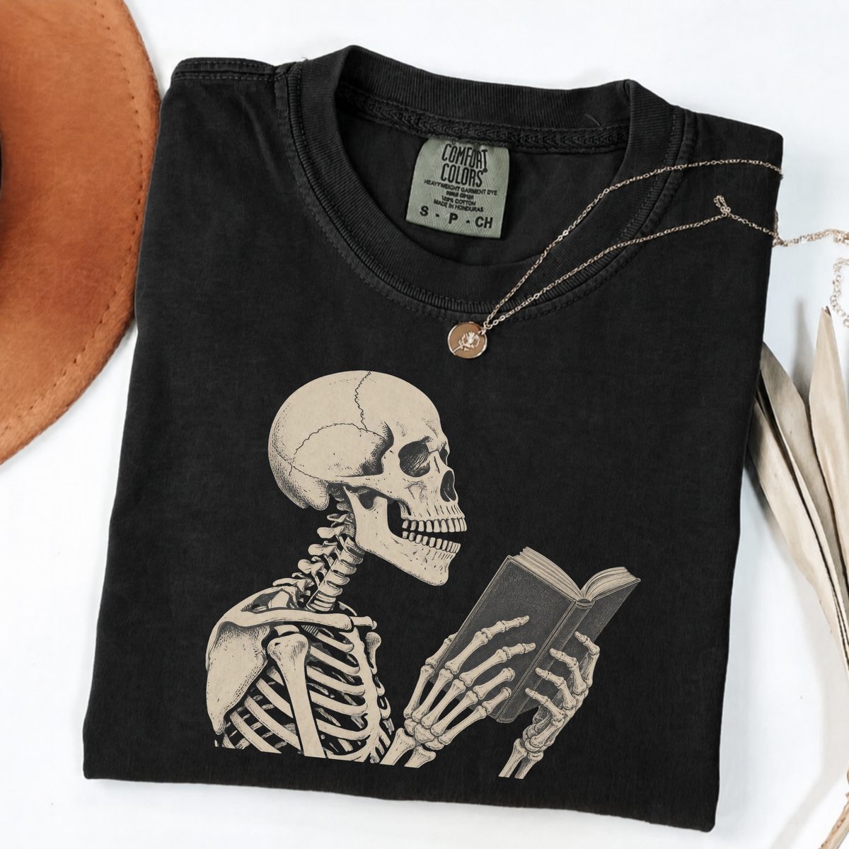 Black Comfort Colors book lover shirt featuring a vintage skeleton reading
