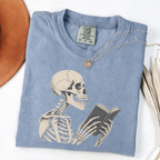 Blue Jean Comfort Colors book lover shirt featuring a vintage skeleton reading