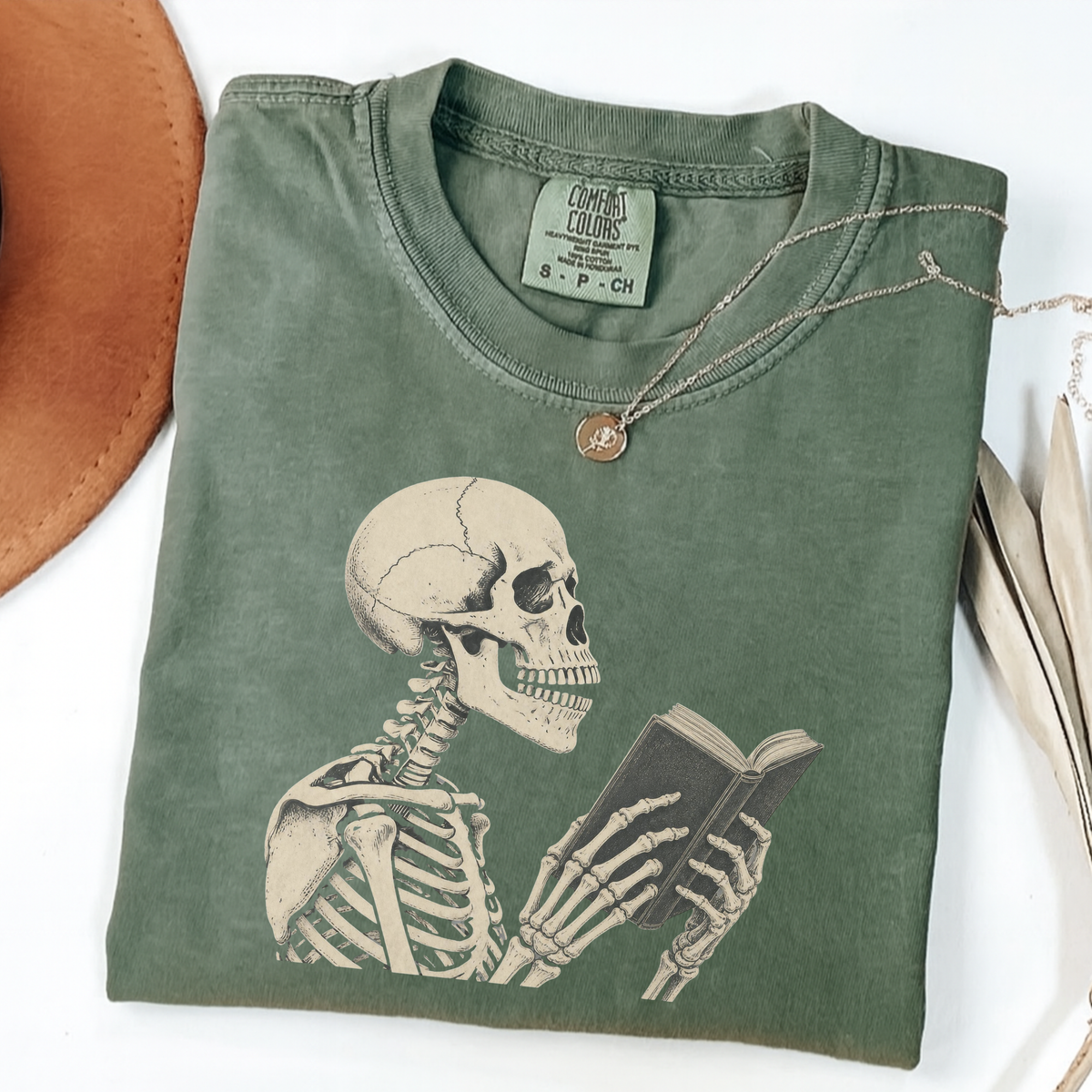 Moss Comfort Colors book lover shirt featuring a vintage skeleton reading