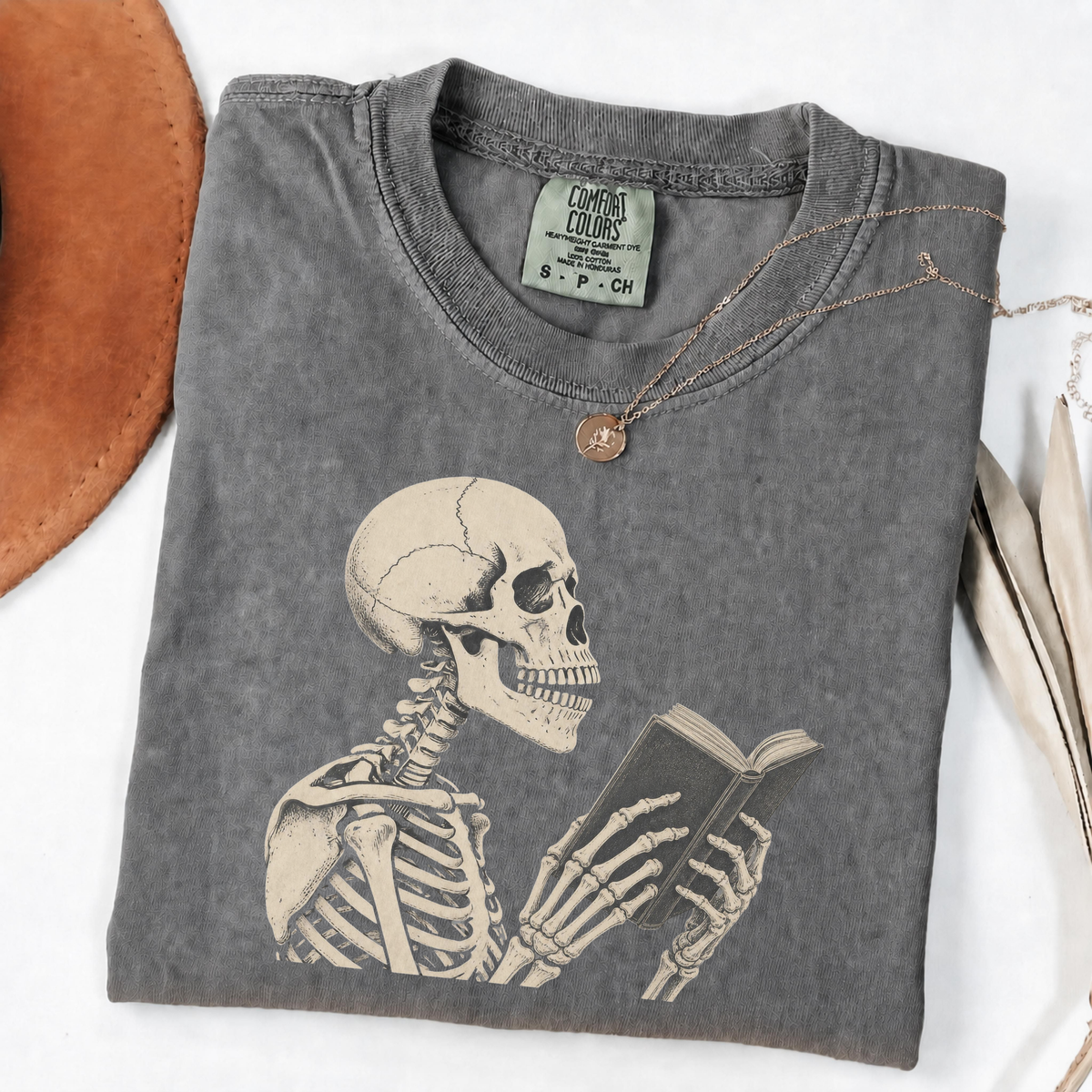 Pepper Comfort Colors book lover shirt featuring a vintage skeleton reading