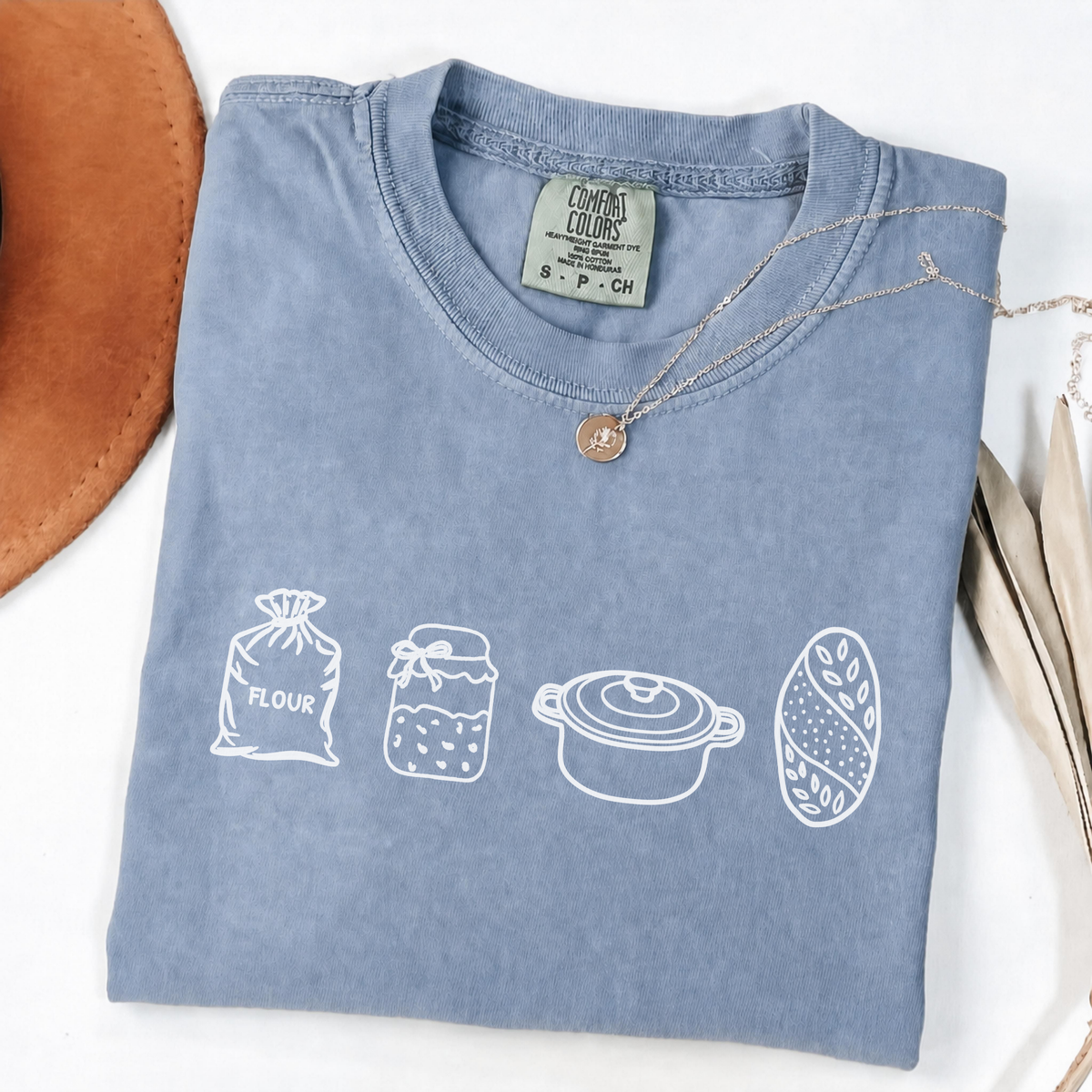 Blue Jean sourdough baker shirt with flour, starter, Dutch oven and bread illustrations.
